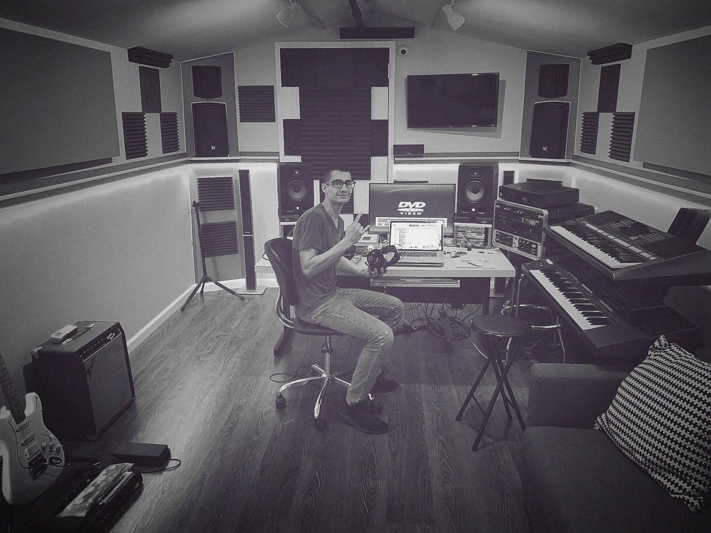 ALAN in his studio with keyboards, monitors and a guitar